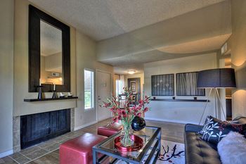 Dining Room with Wood Inspired Floors, ;arge Black Mirror, Flowers is Vase, Fireplace and Window at Fountains of Fair Oaks, California